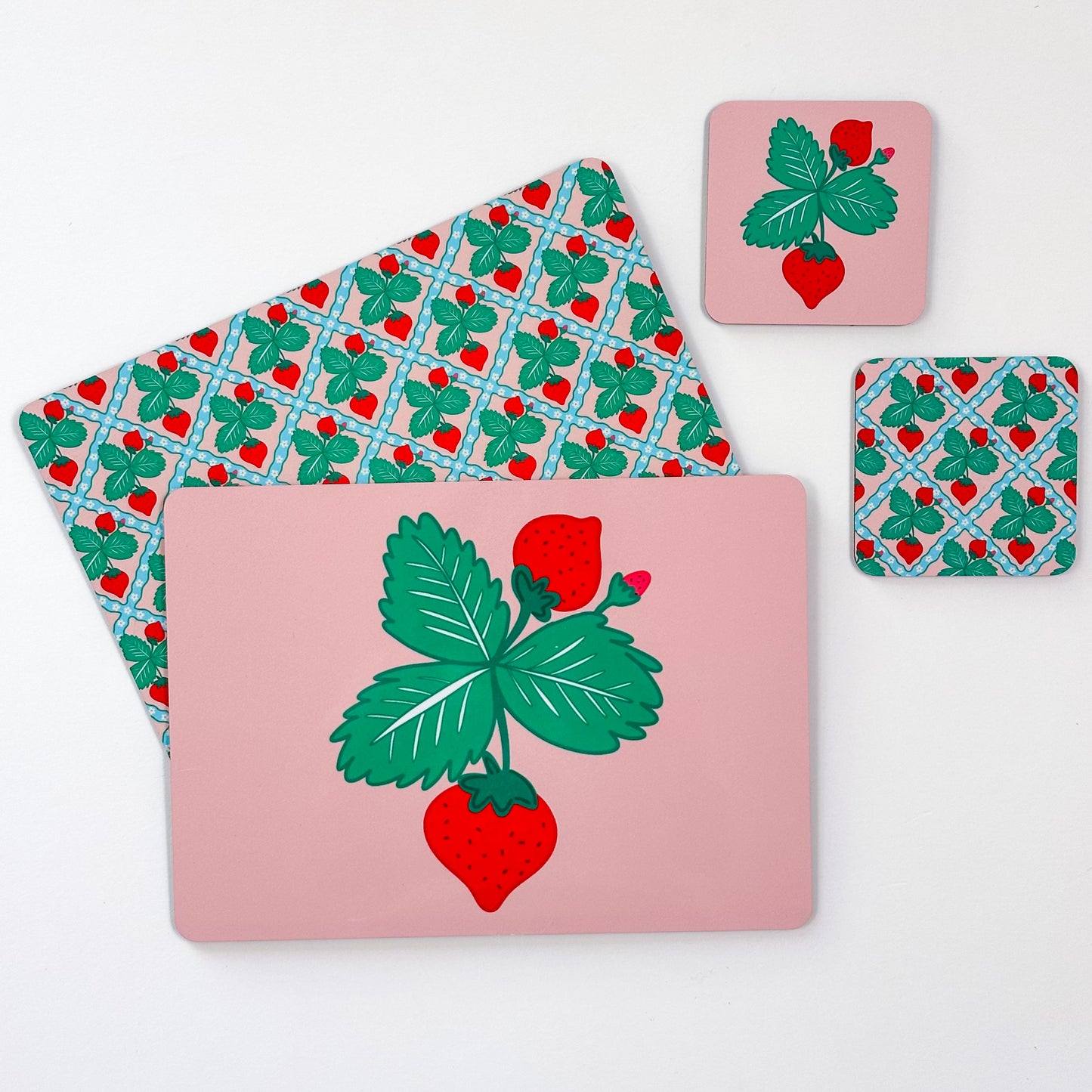 Set of placemats and coasters with strawberry design on a pink background, cottage core colourful home decor