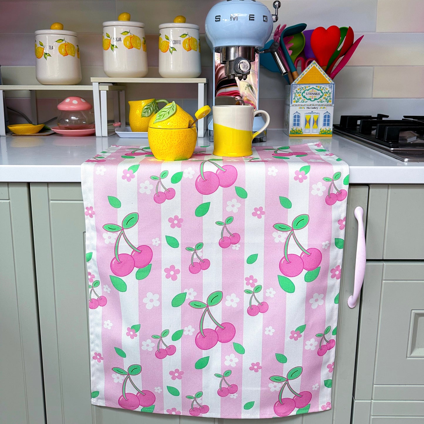 pink striped kitchen towel with cherries