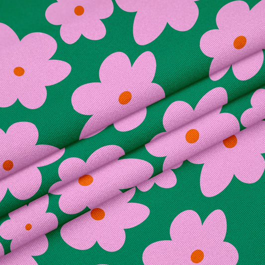 Pink daisy fabric on dark green background 