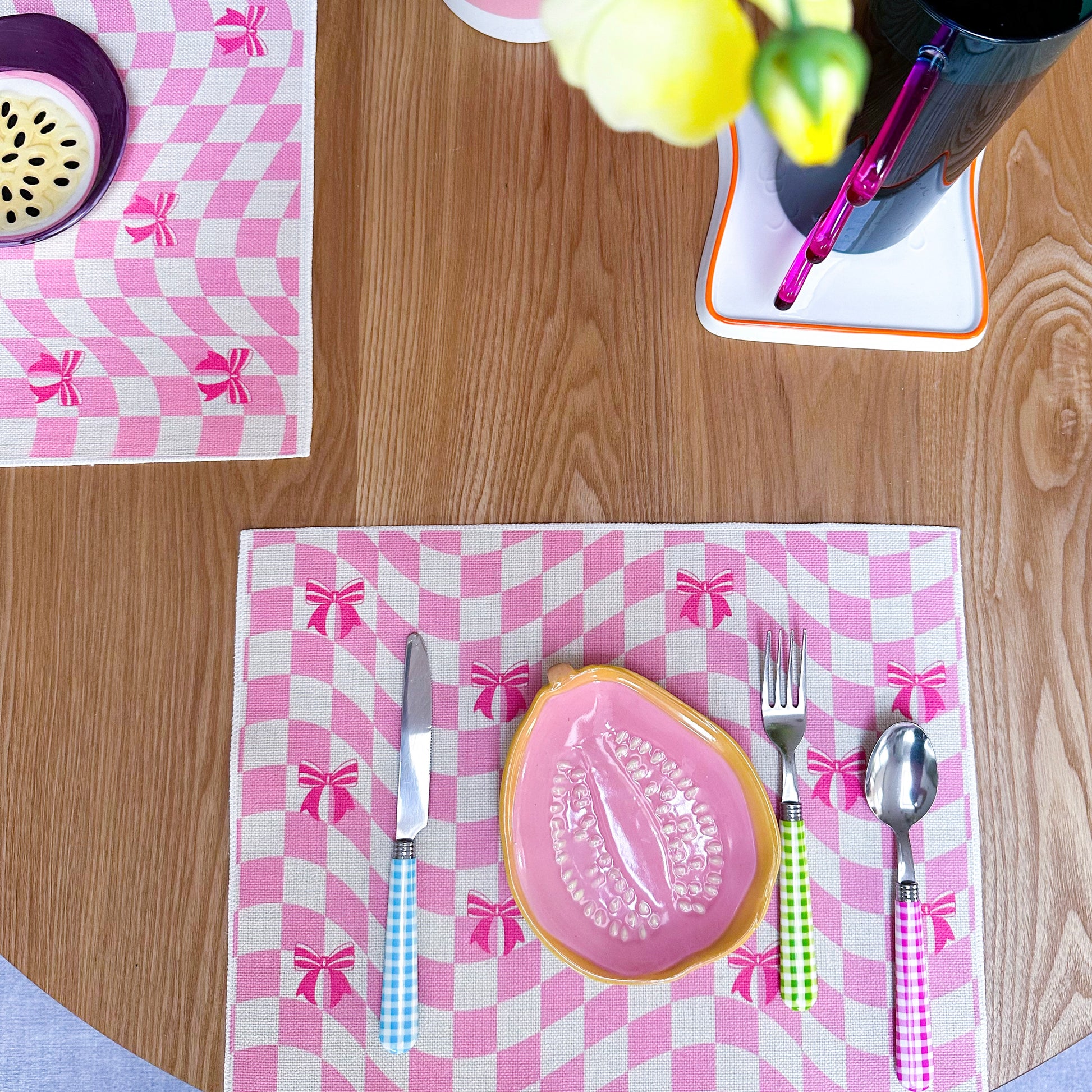 Checkered placemat with pink ribbons