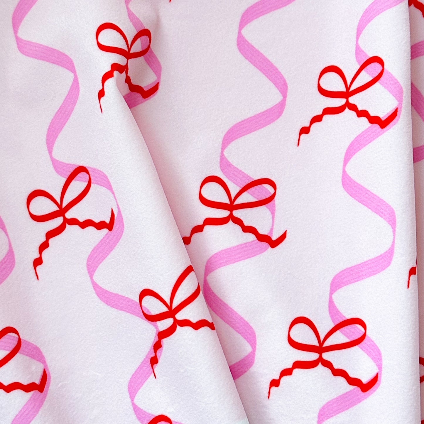 ‘Mad about the Bows’ fabric with bows and ribbons in pink and red