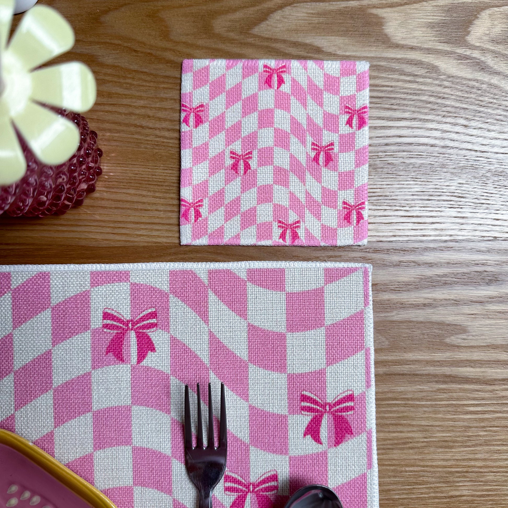 pink coaster set with ribbons and checkered pattern