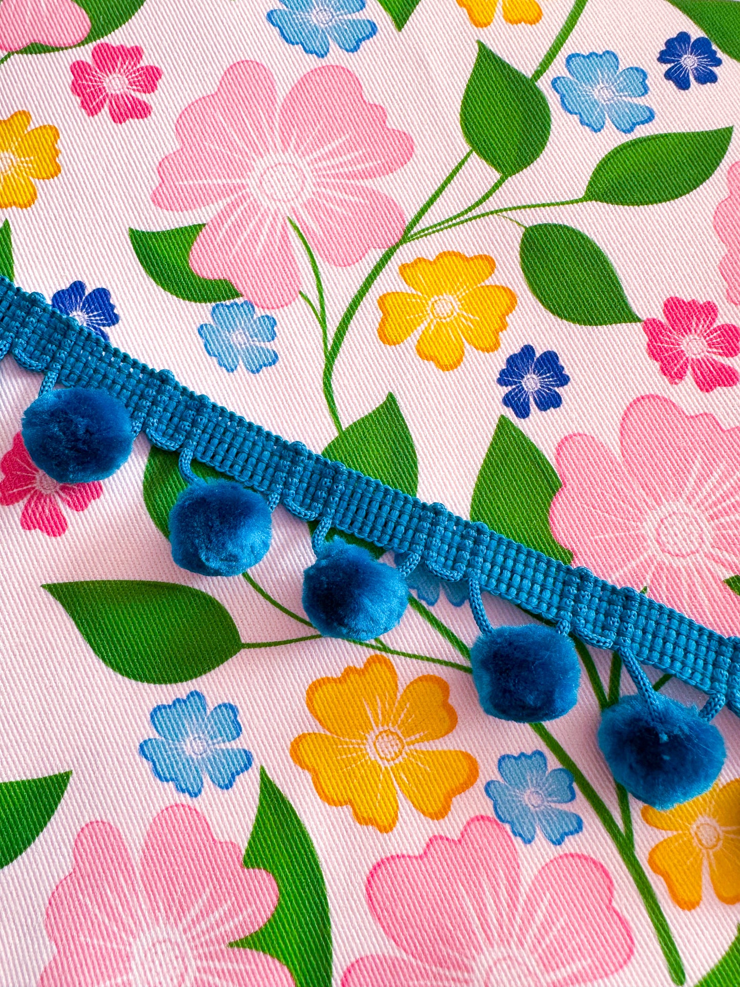 Floral fabric with blue pom-pom trim