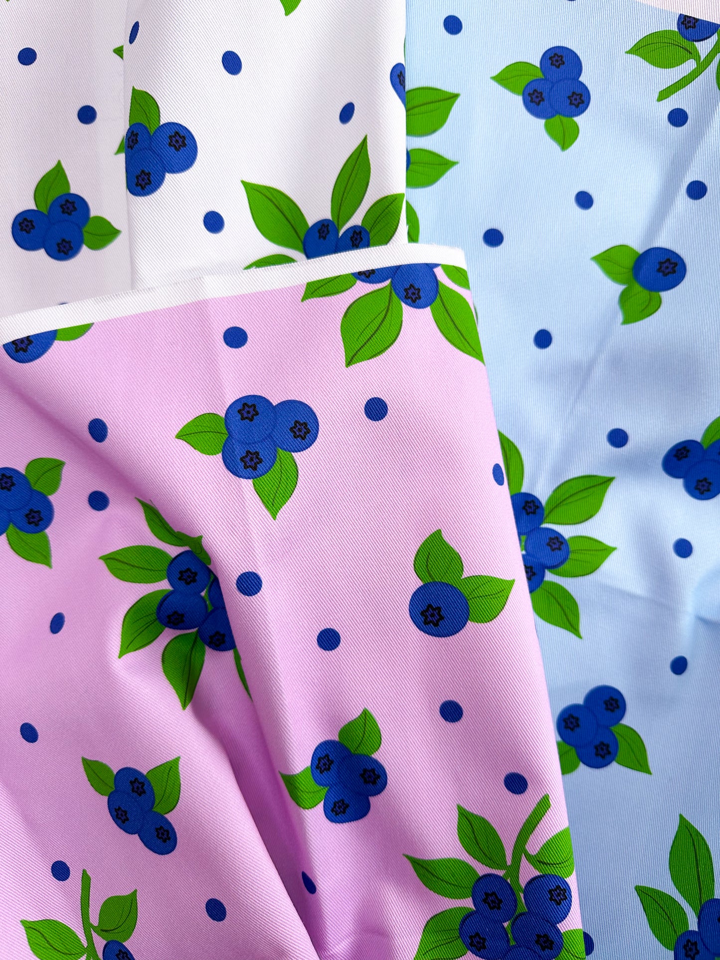 Fabric swatches in white, pink, and blue with blueberry pattern, fruity fabric, colourful fruit fabric, elegant interior, kitchen fabric