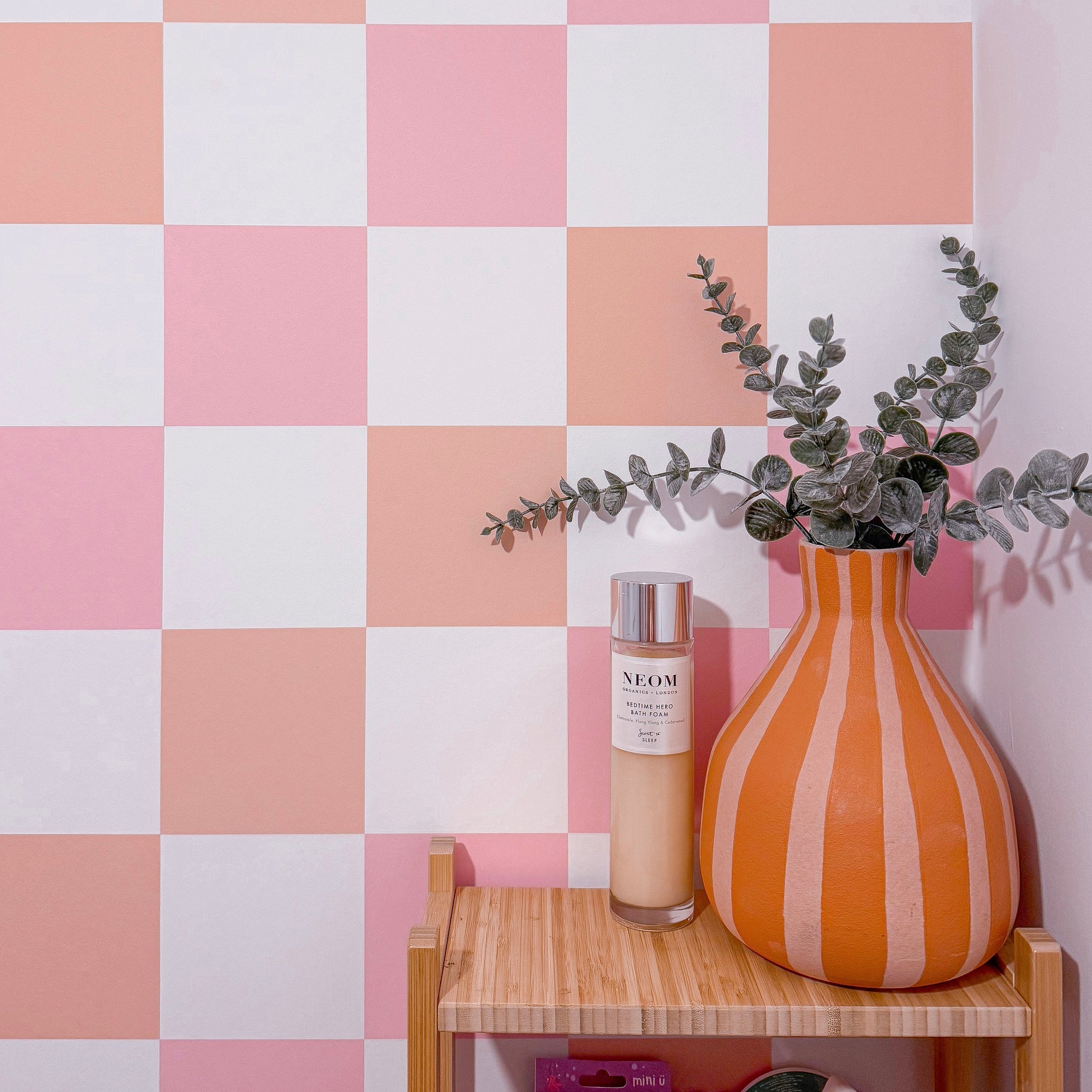pastel peach and pink retro wallpaper with checkerboard design for bathroom living room bedroom colourful interior