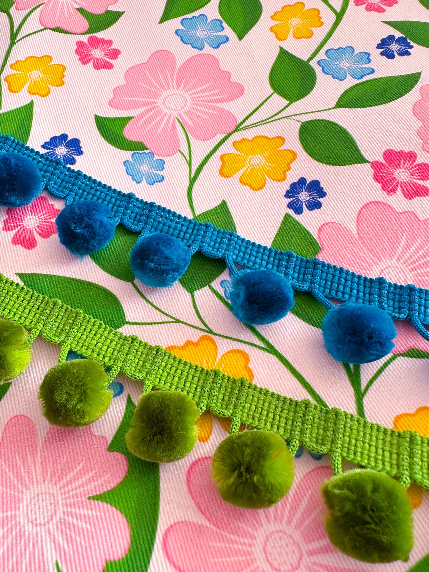 floral fabric with blue and green pom-pom trim