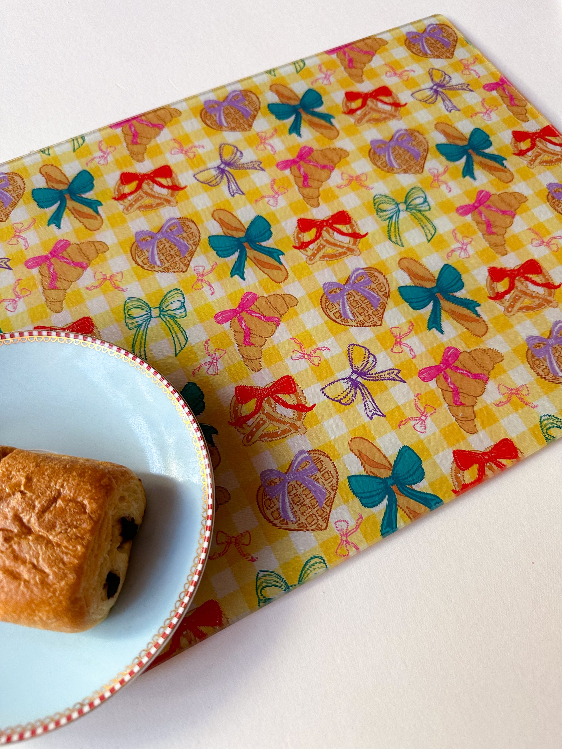 glass worktop saver cutting board with croissant design in yellow