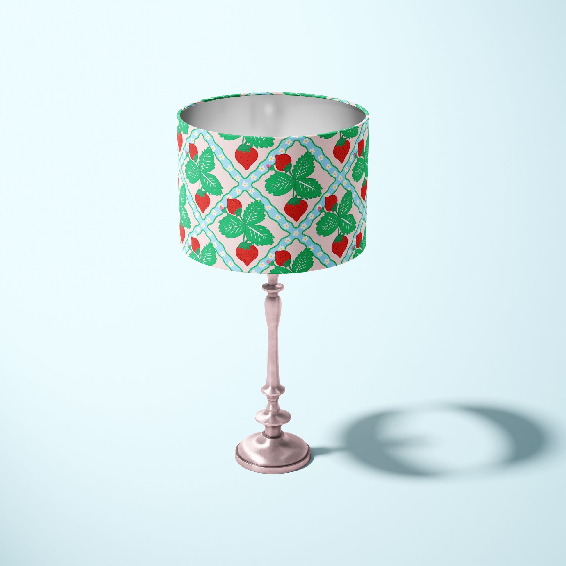 decorative lampshade featuring strawberry pattern on a light blue and pink background