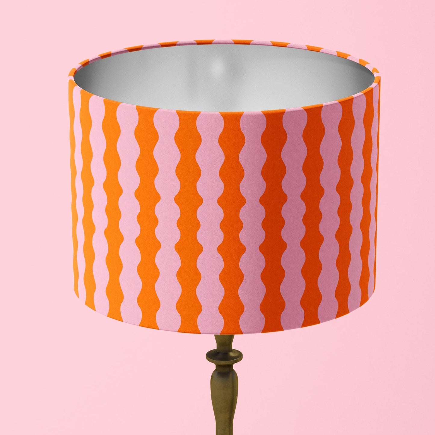 Table lamp with a striped orange and pink shade 